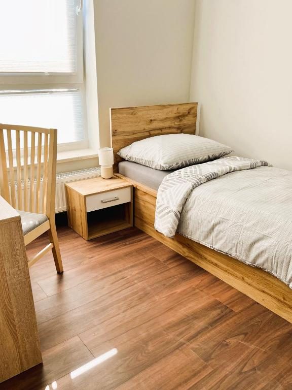 Single room with wooden bed and desk